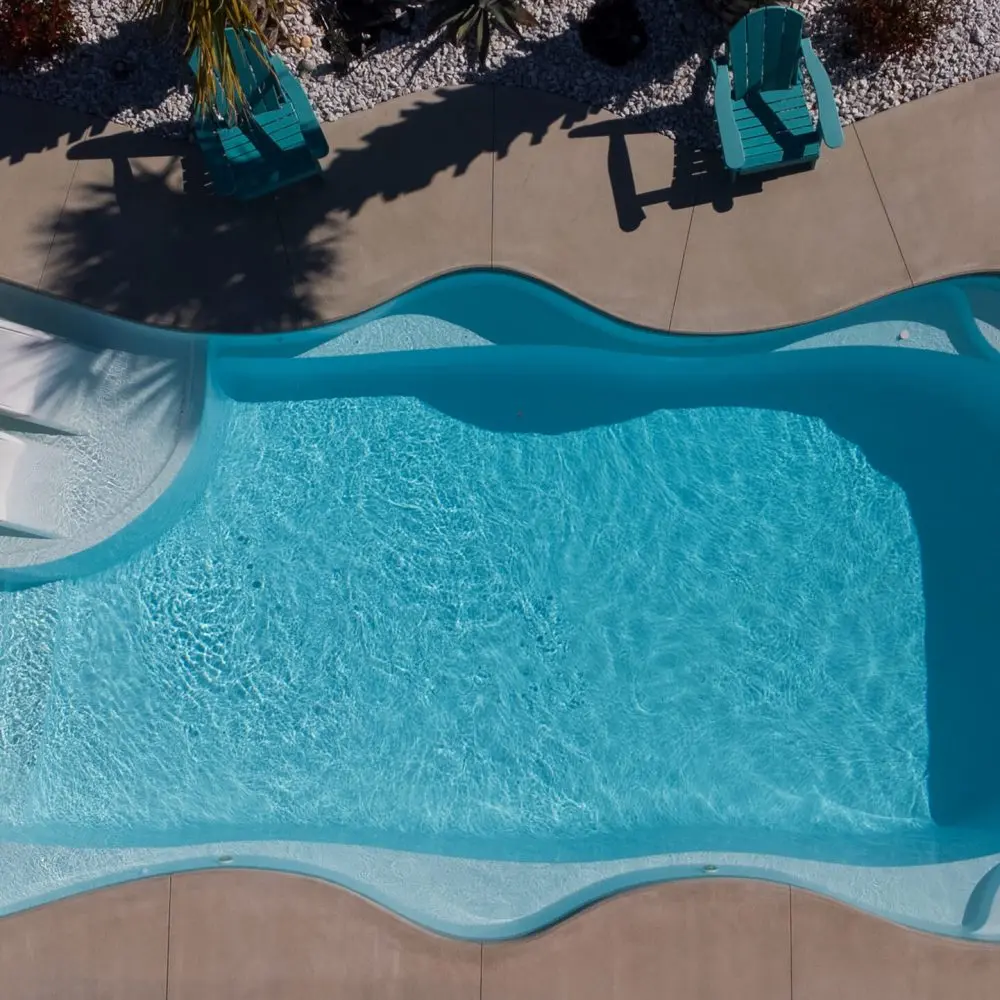 Coral Sea fiberglass pool with tanning ledge sun shelf in Arctic Shimmer